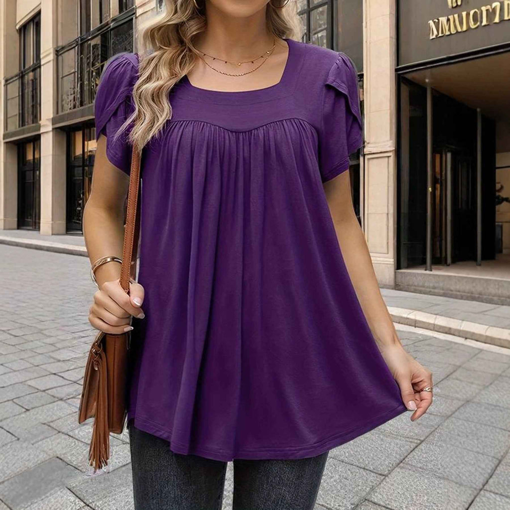 The Woman Is Wearing A Breathable Comfortable Top With Bubble Sleeves