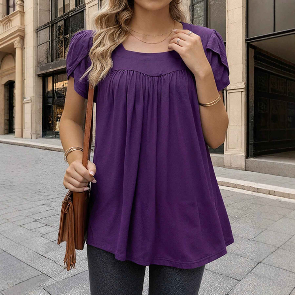 The Woman Is Wearing A Breathable Comfortable Top With Bubble Sleeves